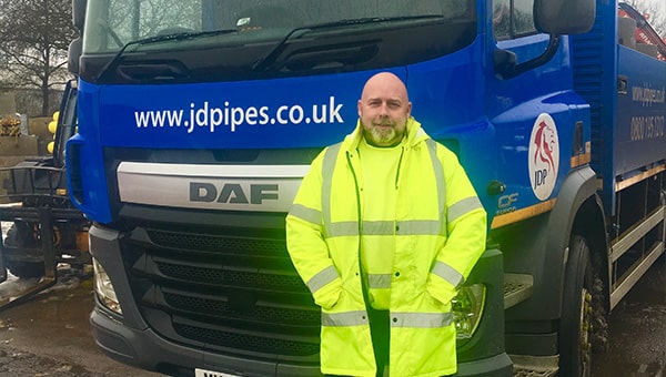 Stephen Cooper in front of JDP lorry.