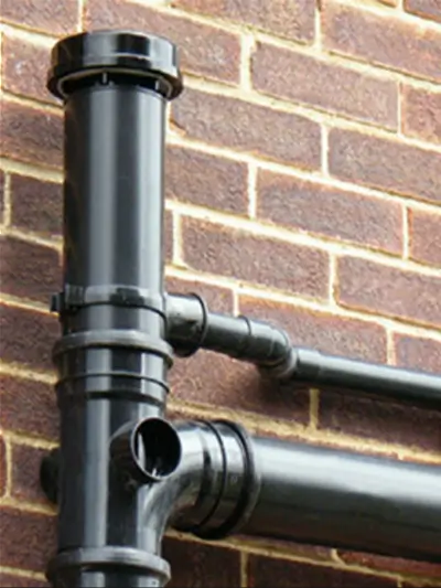 Above-ground drainage pipe installed as a soil stack.