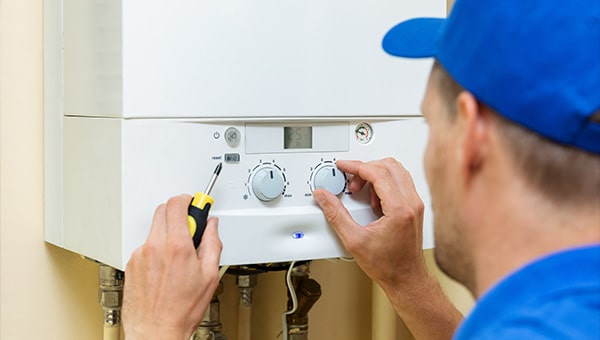 Person servicing a boiler.