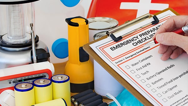 An emergency preparation checklist alongside batteries and torches.