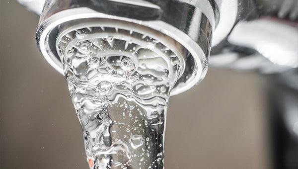 Water coming out of a tap.
