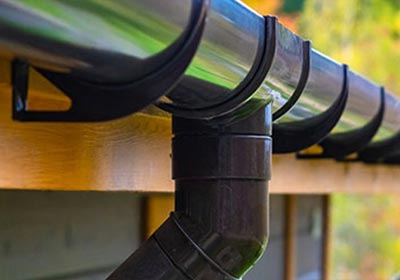 A manhole cover being laid in a road.