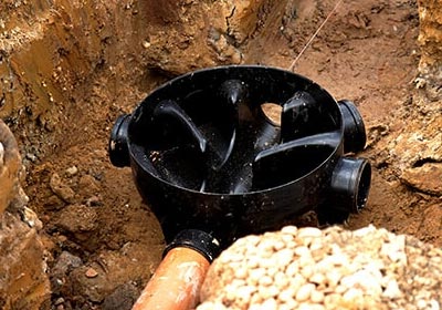 A PPIC inspection chamber being installed in a drainage system.