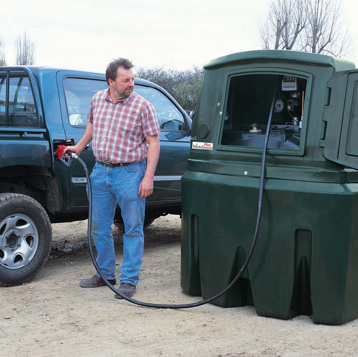 Man filling a truck with petrol from a fuel station.