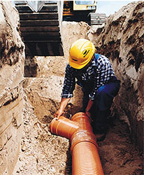 Man laying sewer pipe