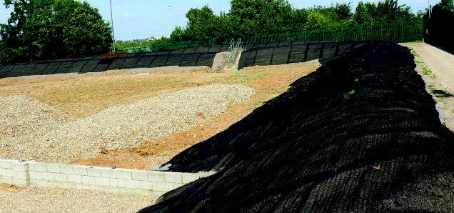 A black erosion control mat on a steep slope.