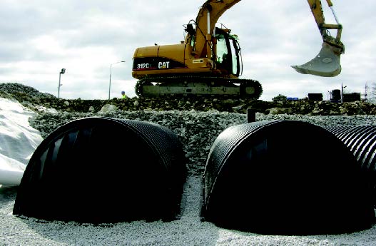 Large digger above tunnel system being installed.