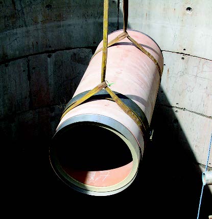 Clay pipe being lowered into tunnel.