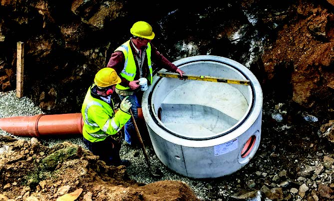 Two construction workers measuring a perfect base.